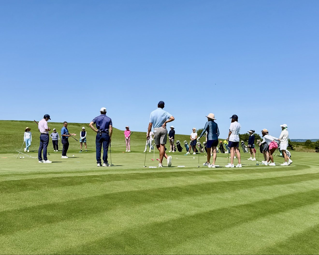 Addison Craig teaching a group clinic on the putting green